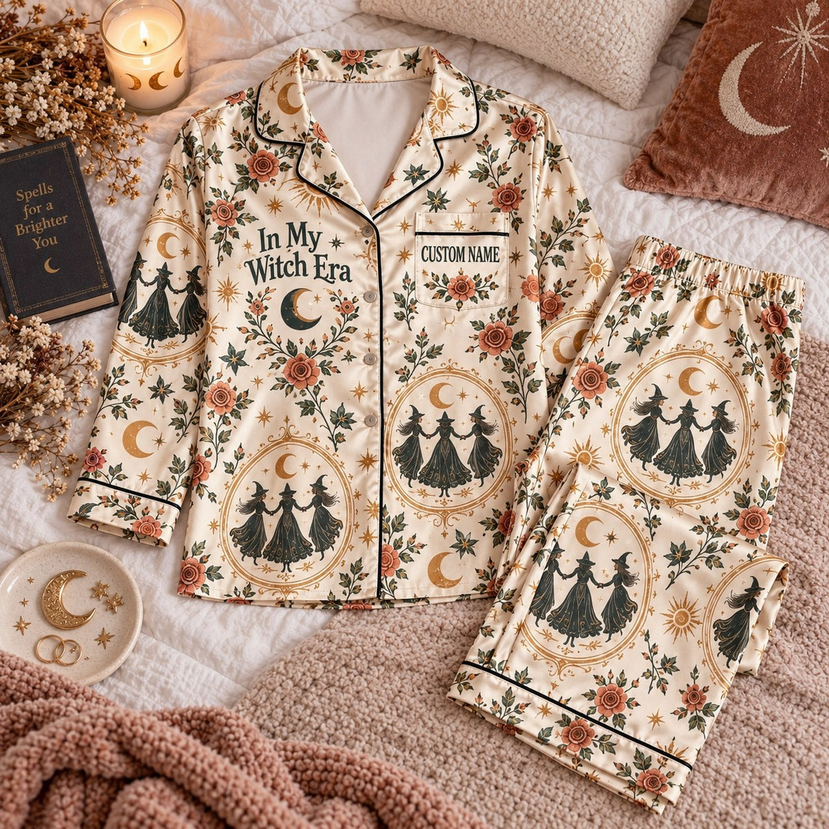 cream witch print satin pajamas flat lay with a custom name on the chest