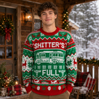 young man smiling in the shitters full ugly christmas sweater by a