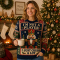 woman wearing a nutcracker ugly christmas sweater in front of a lit