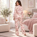 woman sitting on bed in personalized breast cancer awareness satin pajamas