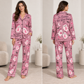 front view of pink satin halloween pyjamas with breast cancer ghost print