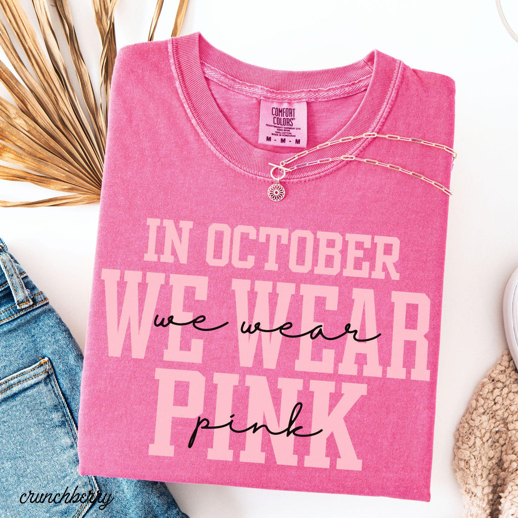 pink graphic tee reading in october we wear pink folded on white