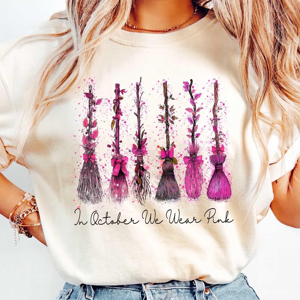 cream sweatshirt with breast cancer awareness witch broom print modeled outdoors