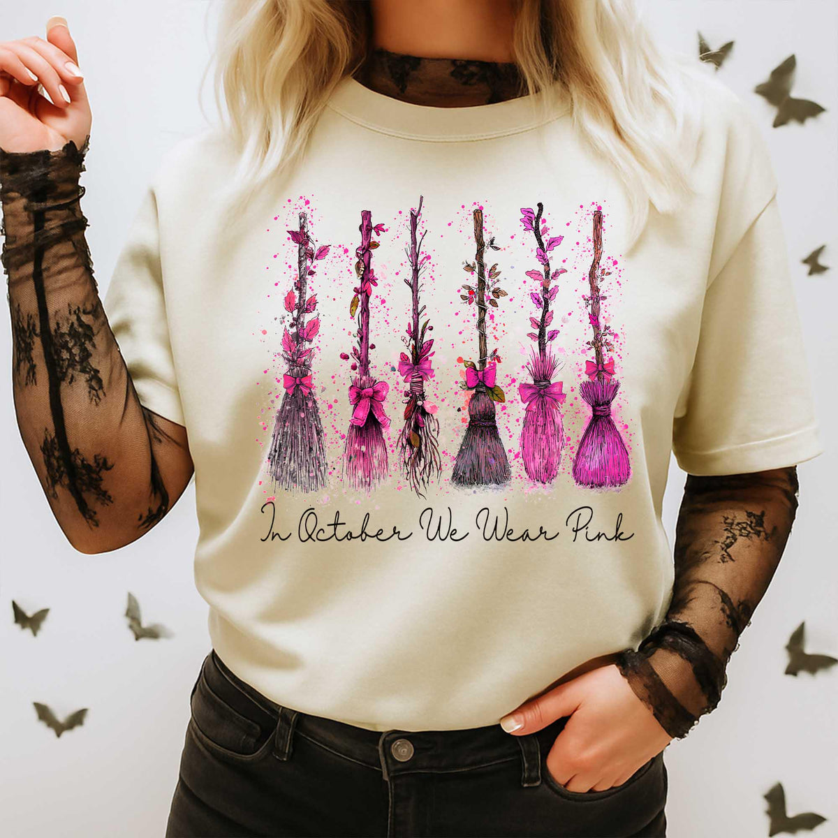 beige t-shirt with pink ribbon witch broom breast cancer design worn with