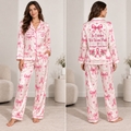 woman modeling a pink plaid satin pajama set with breast cancer ribbon