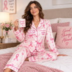 seated woman in pink bow satin pajamas with a custom name on the chest