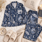 navy moon print satin pajamas flat lay with a custom name on the chest