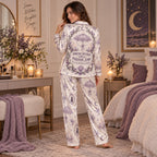 model reading spooky-themed book while wearing purple witch satin pajama set