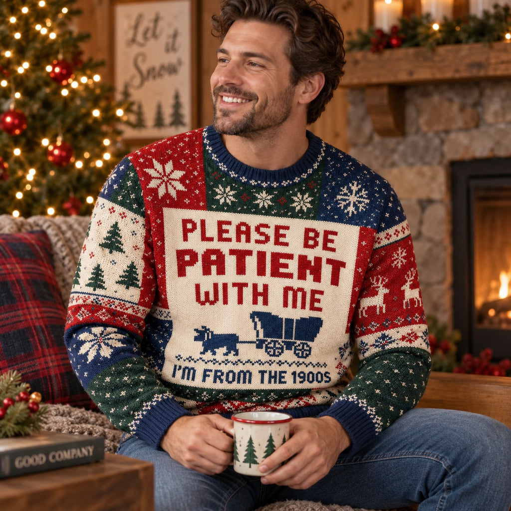 man smiling in a covered wagon ugly christmas sweater holding a holiday