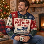 man smiling in a covered wagon ugly christmas sweater holding a holiday