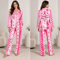 woman wearing a pink and white satin pajama set printed