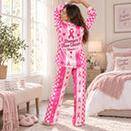 woman reading in the pink and white breast cancer awareness satin pajama