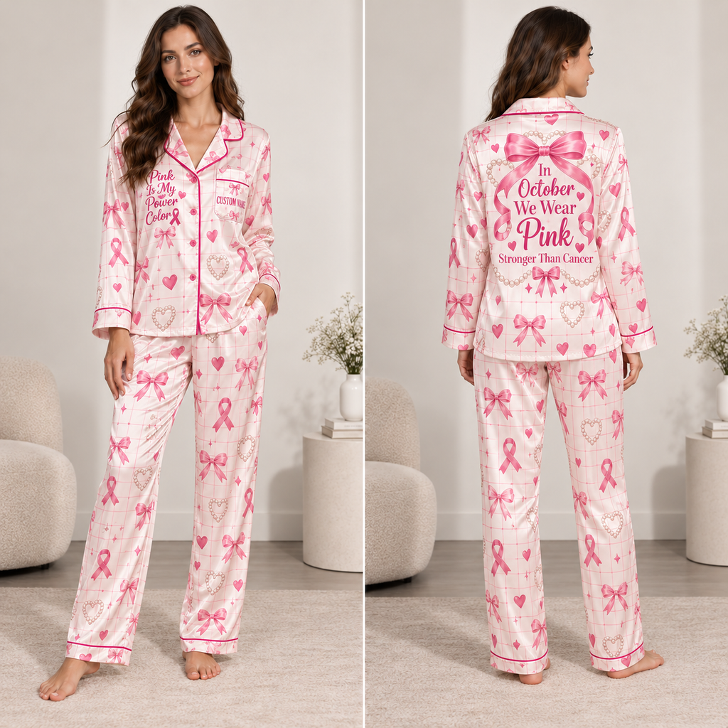 woman modeling a pink satin pajama set with breast cancer awareness ribbon