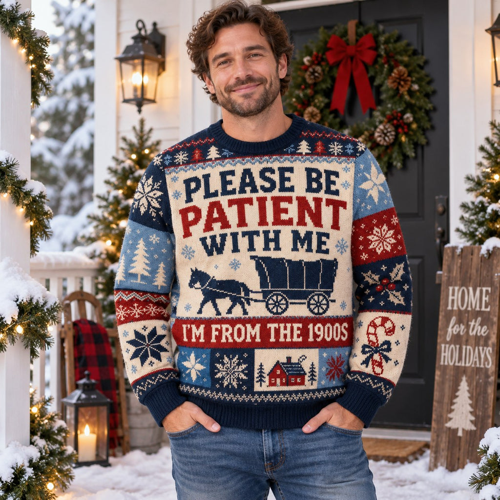 man standing on a porch wearing a printed holiday sweater with snowflakes