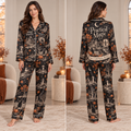 front view of black satin Halloween pajama set with all-over haunted house