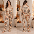 woman modeling a satin pajama set with a haunted house and black