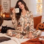 woman on a bed holding a Spooky Season mug in the satin