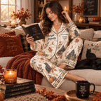 woman reading on couch in witch themed satin sleepwear set