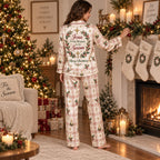 plaid christmas pajamas with cross detail hanging by fireplace