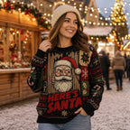 woman smiling in a knit holiday sweater featuring a santa portrait and