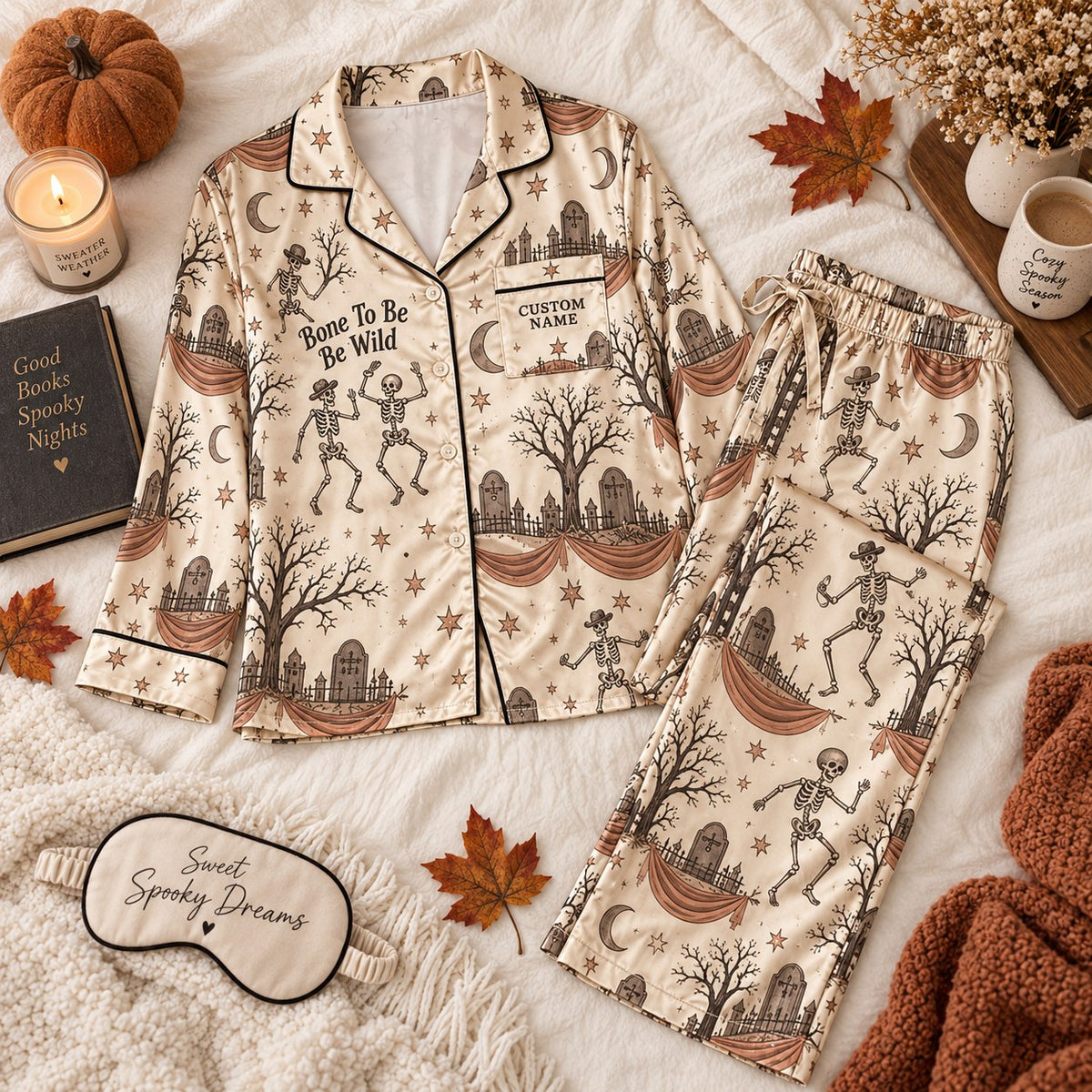 flat lay of cream skeleton satin pajamas with a custom name on the chest