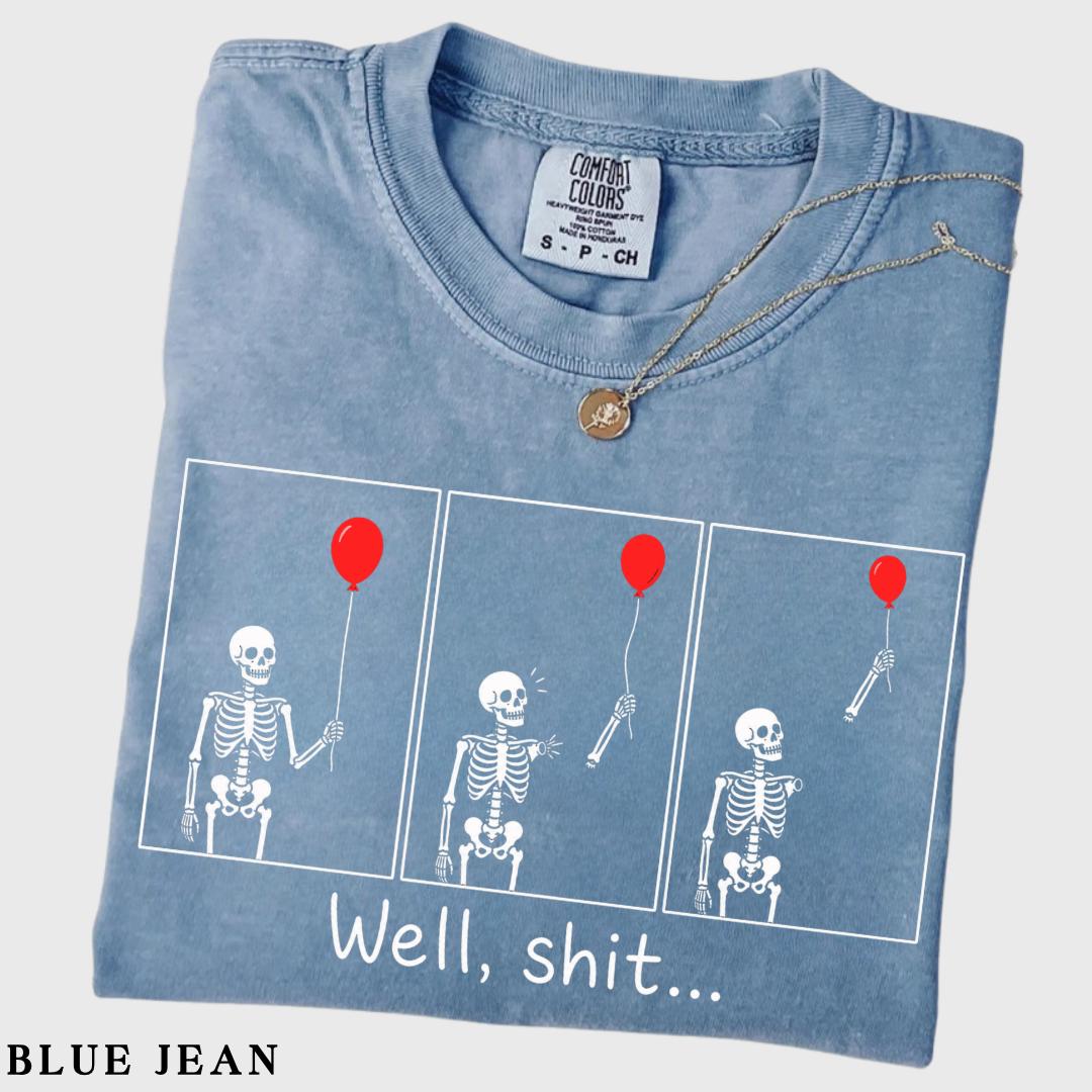 folded blue jean graphic tee with skeleton and red balloon comic print
