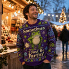 man wearing a purple ugly christmas sweater featuring a cartoon frog and