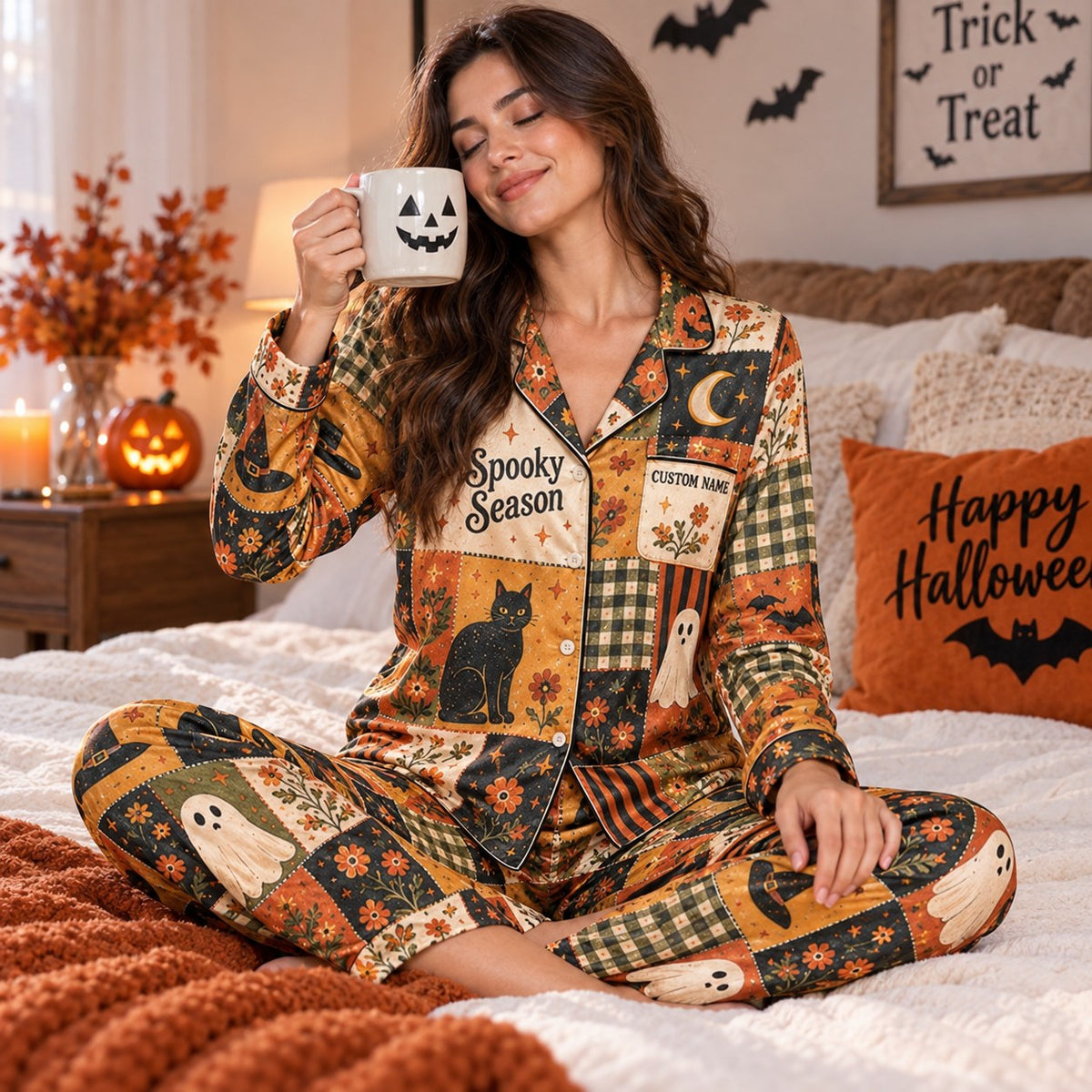 halloween satin pajama set worn on bed with pumpkin mug and happy
