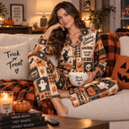 woman in a halloween bedroom holding coffee wearing a satin pajama set