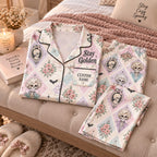 pastel skeleton satin pajamas on a bench with a custom name on the chest