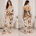 woman modeling Stay Spooky Halloween satin pajama set with all-over ghost pumpkin