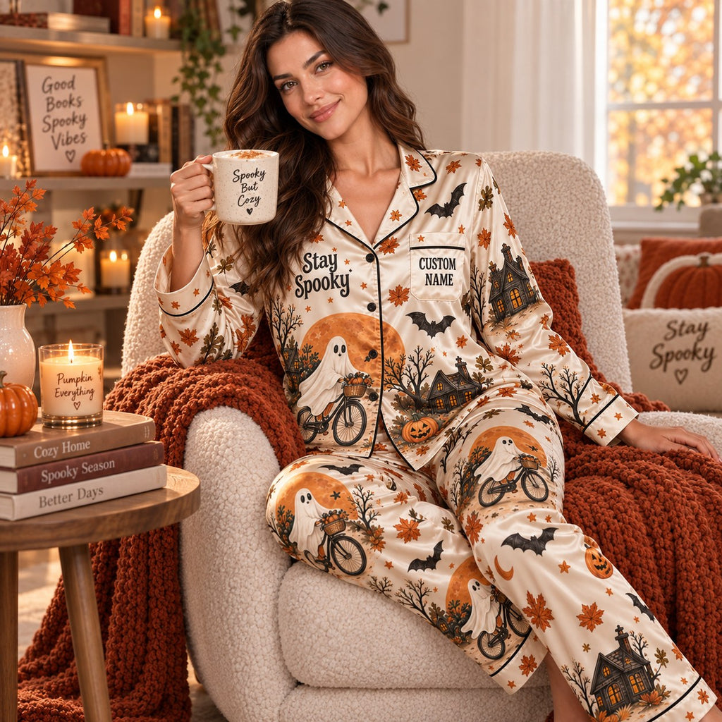 model relaxing on bed in Halloween satin pajamas beside a Spooky Season
