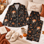 flat lay black ghost bicycle satin pajamas with a custom name on the chest