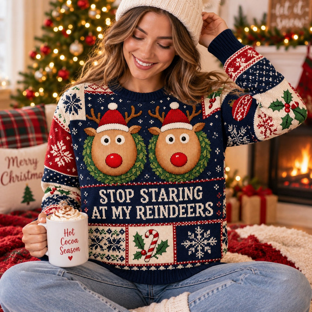 woman in a cream beanie showing the reindeer holiday sweater design with