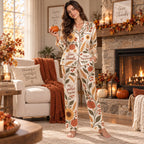 woman sitting on bed holding mug in sunflower and pumpkin thanksgiving lounge
