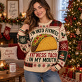 woman wearing a taco christmas sweater in a cozy living room with