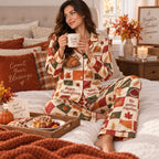 model by a fireplace holding a mug in printed thanksgiving pyjamas