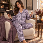 model standing in halloween decorated bedroom wearing witch themed satin pajama set