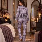 woman reading a book while wearing the halloween witch satin pajama set