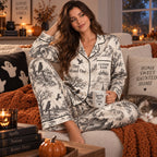 halloween satin pajama set styled with mug and candle beside a stack
