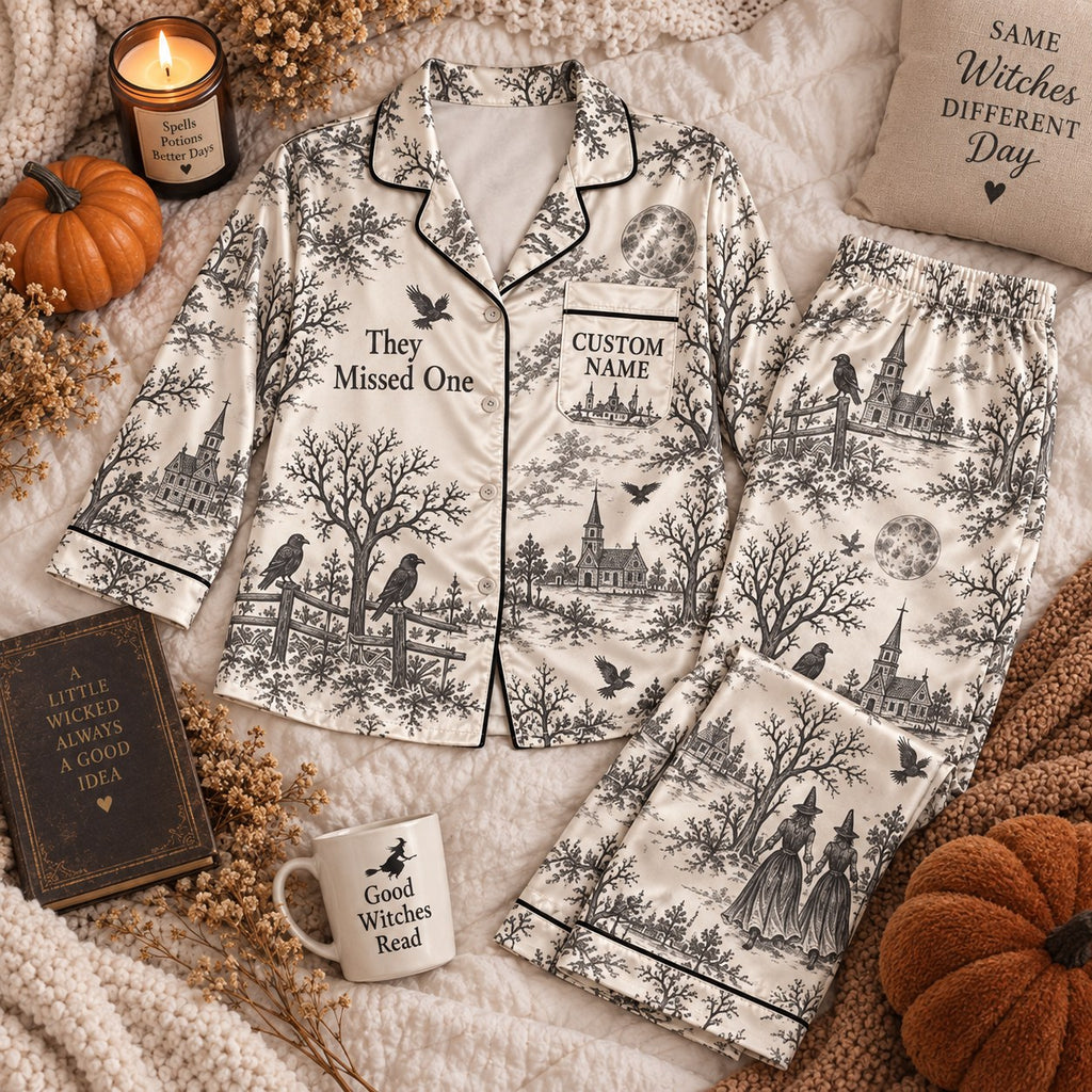 raven toile print satin pajamas flat lay with a custom name on the chest