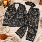 black witch toile satin pajama set flat lay with Escaped Since 1692 on pants