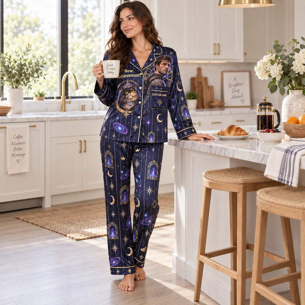 woman reading a book in matching galaxy print satin pajamas