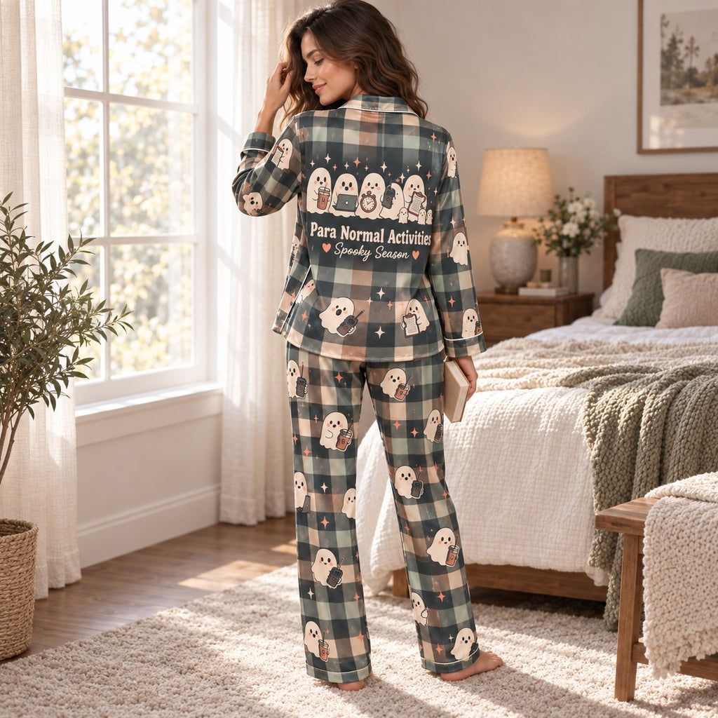 woman sitting on bed holding a Spooky Season mug in plaid ghost