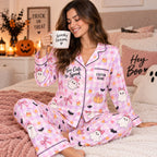halloween satin pajama set modeled on a cozy bed with pumpkins