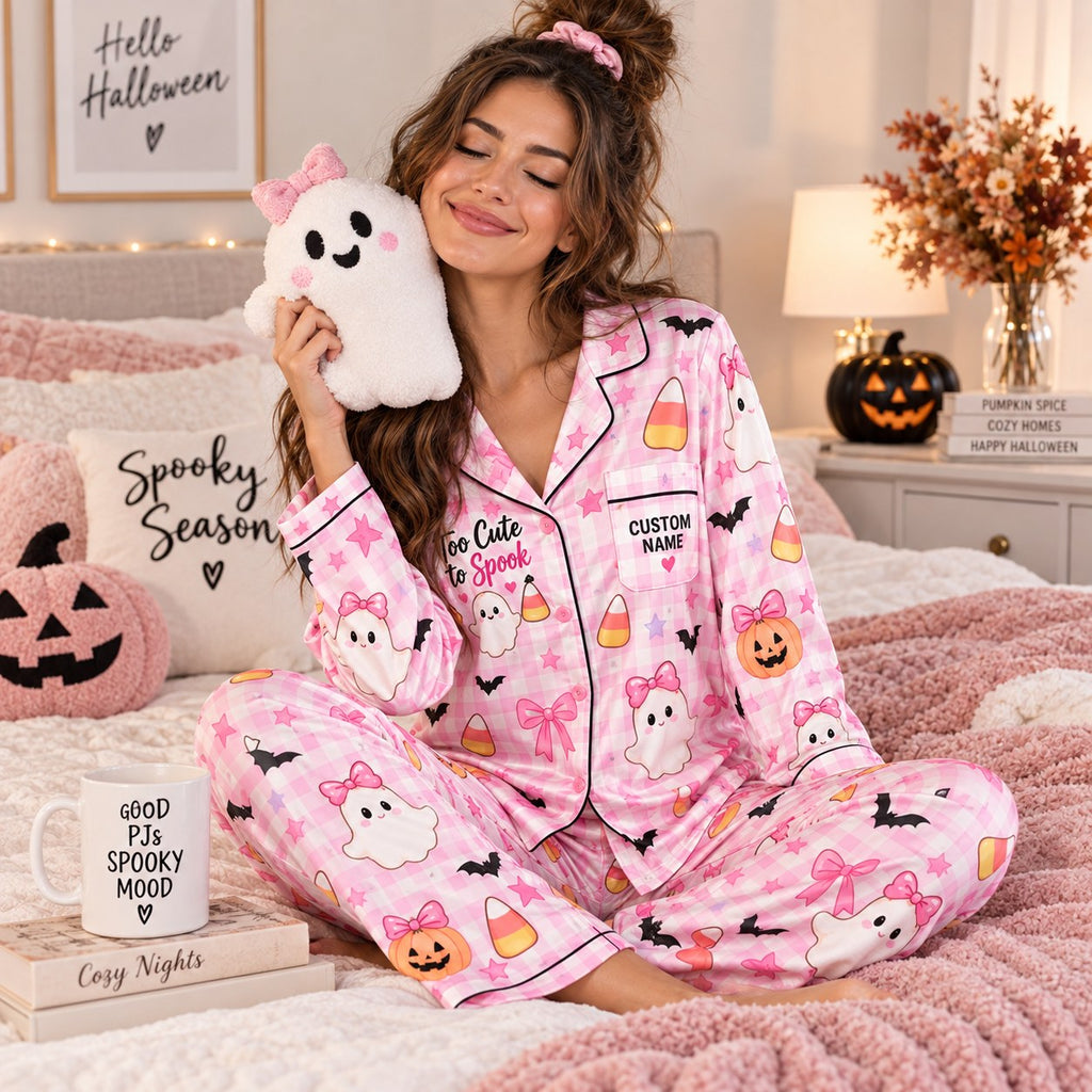 seated woman in pink plaid satin pajamas with a custom name on the chest