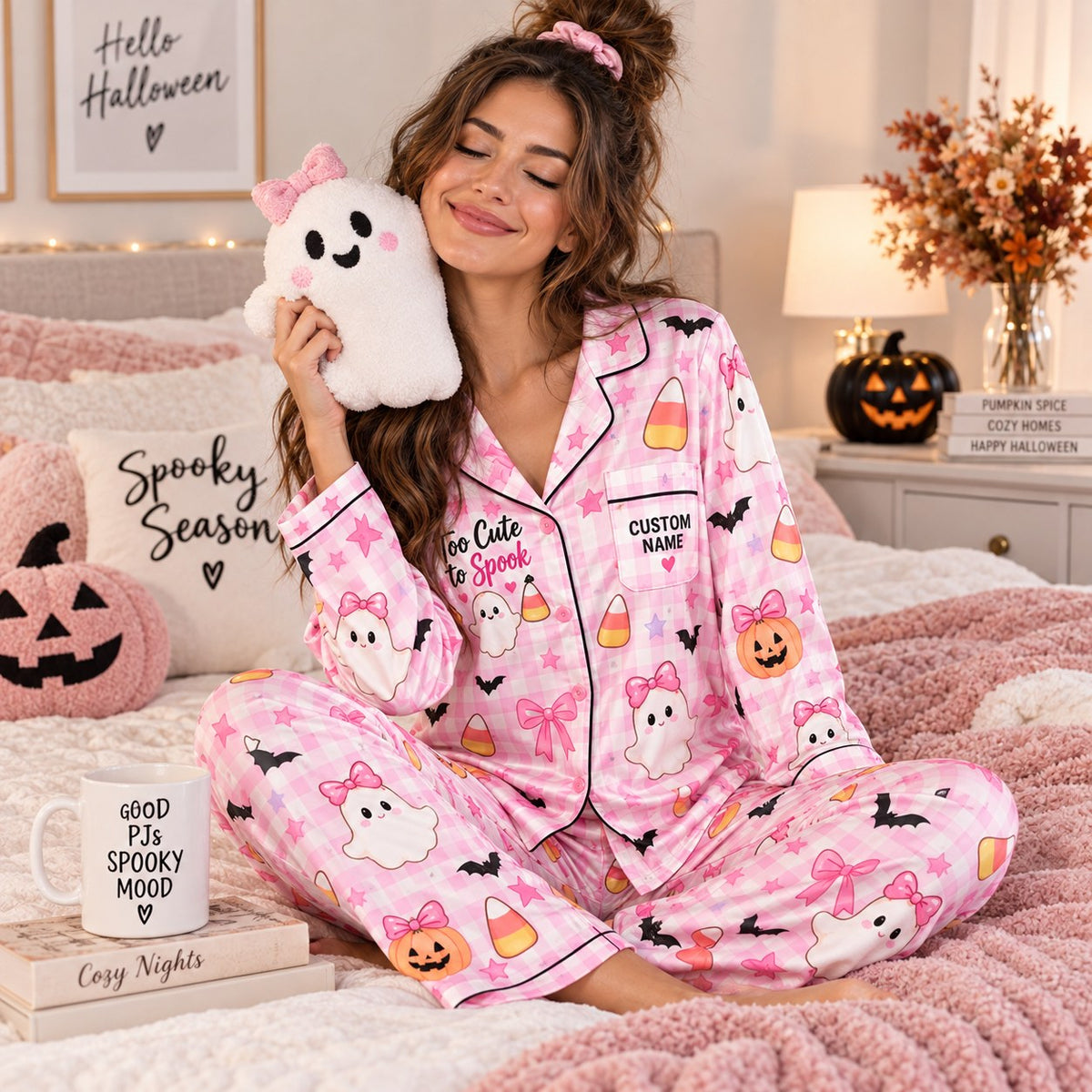 seated woman in pink plaid satin pajamas with a custom name on the chest