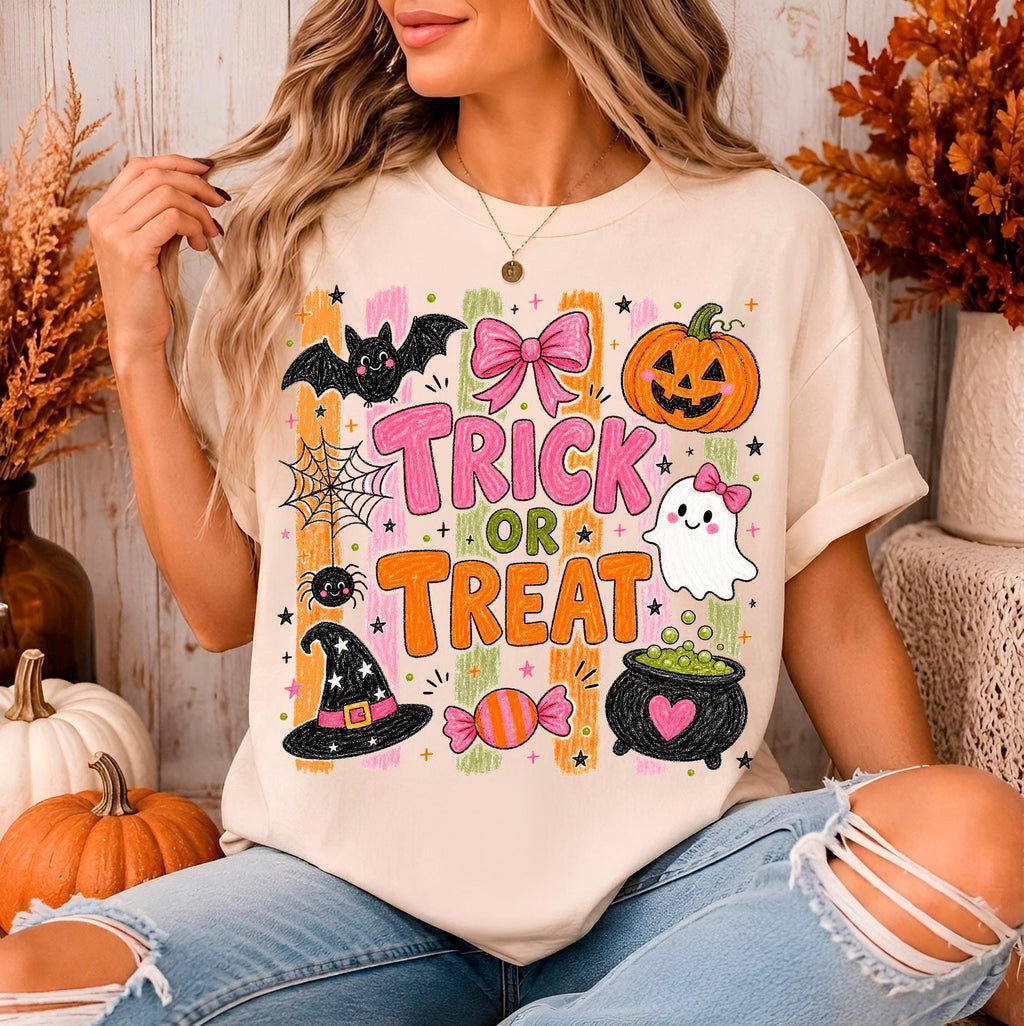 woman wearing a cream halloween graphic tee with trick or treat doodles
