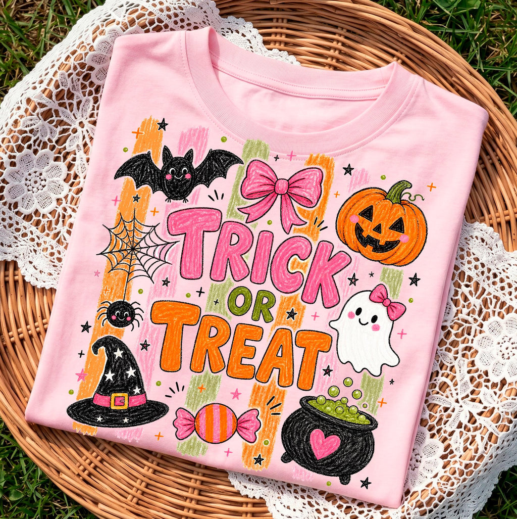 light pink halloween sweatshirt folded in a wicker basket showing the trick