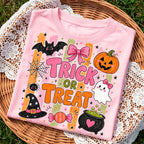 light pink halloween sweatshirt folded in a wicker basket showing the trick